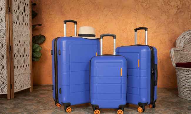 three pieces of blue luggage next to each other