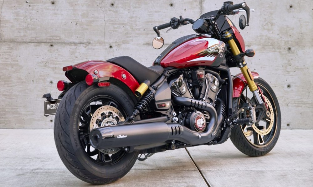 2025 Indian Motorcycle Sport Scout 101 parked in front of a concrete wall right rear three-quarter view.