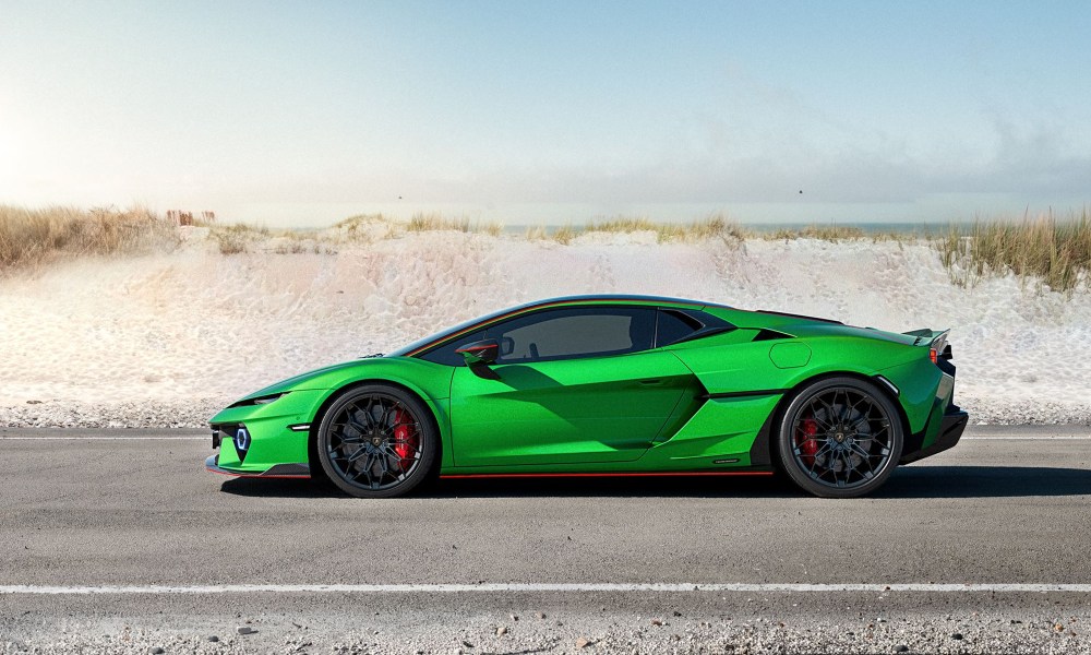 Green Lamborghini Temerario left profile view stopped on a paved road with sand dune in the background.