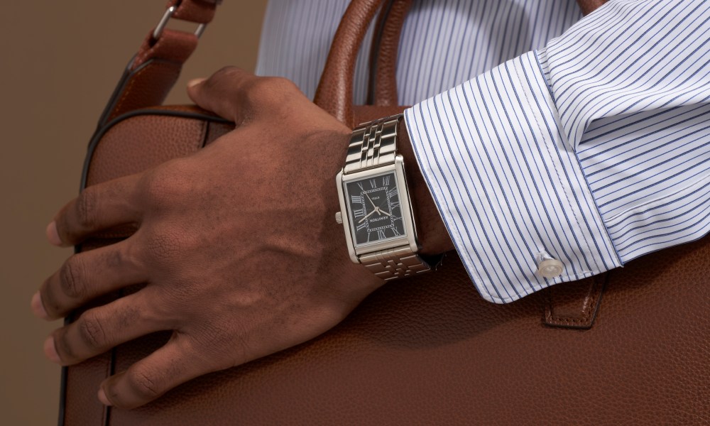 Man wearing Armitron watch with briefcase