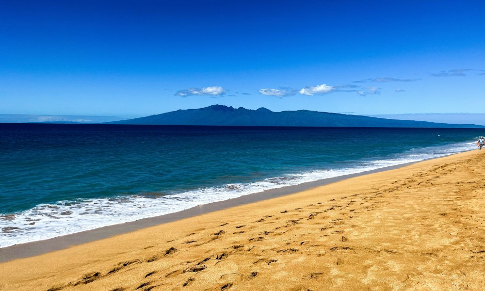 Sand ocean and mountains around Maui