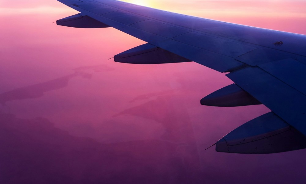 Airplane wing and purple sky