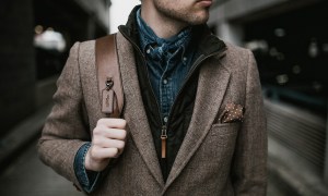 Man in brown suit wearing brown backpack