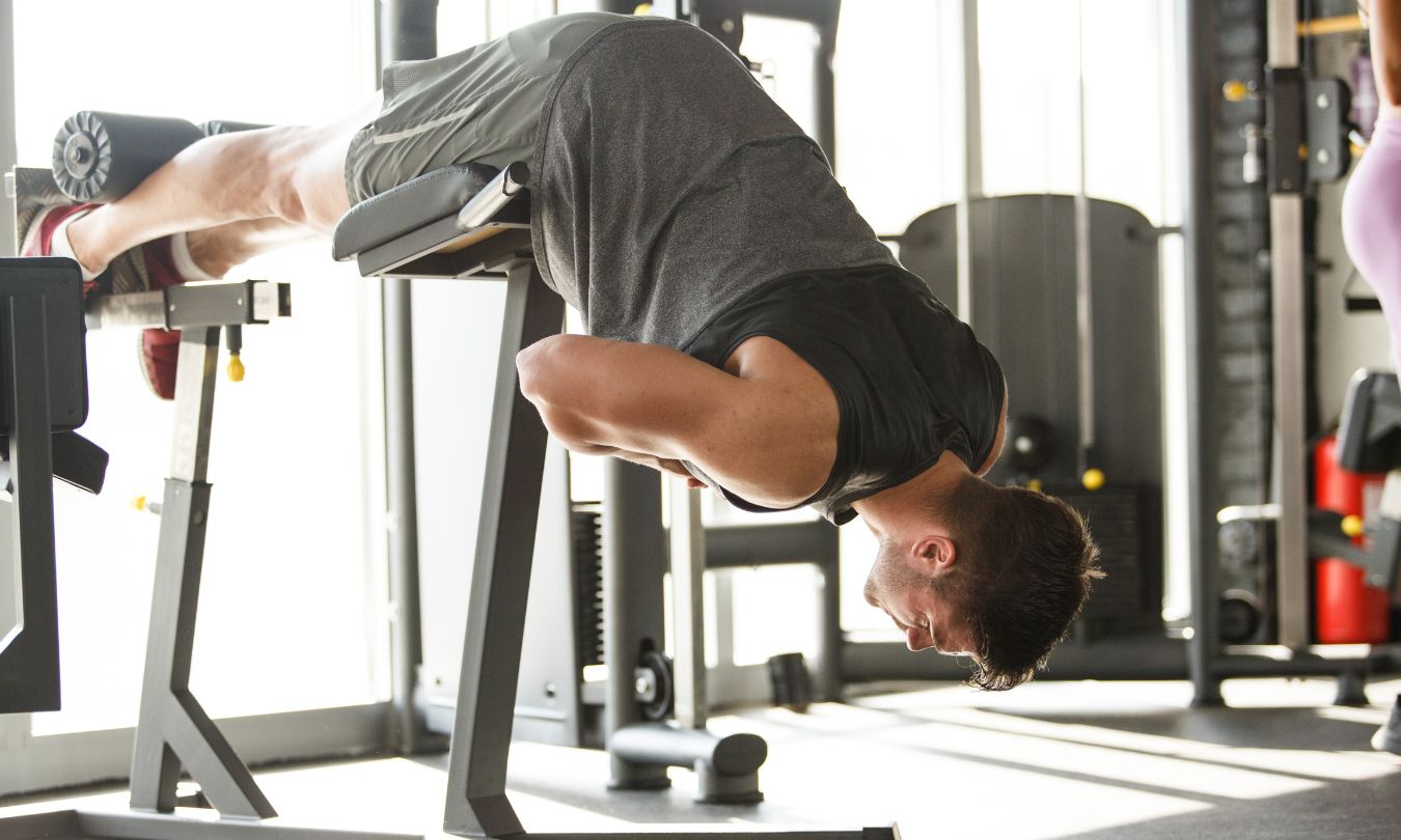 man using a back extension machine 