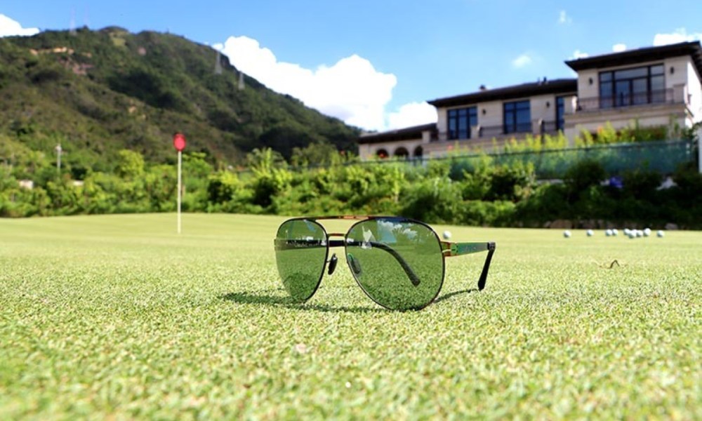 Uswing sunglasses on a golf course.