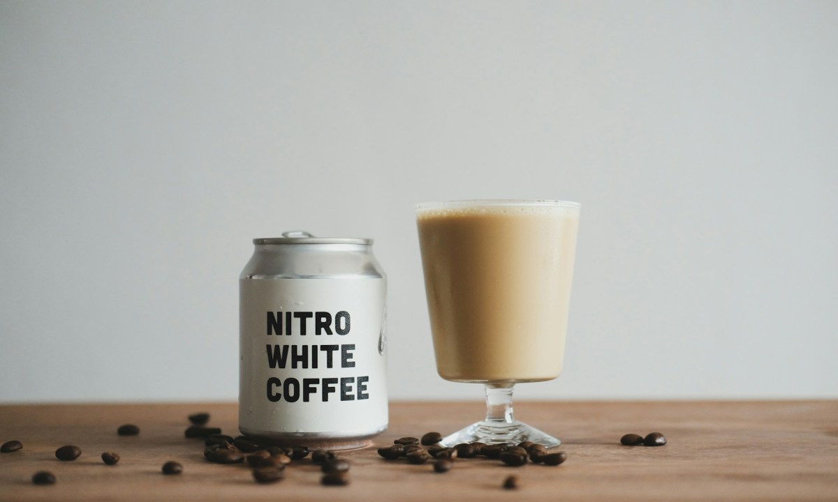 A canned coffee drink poured into a glass.