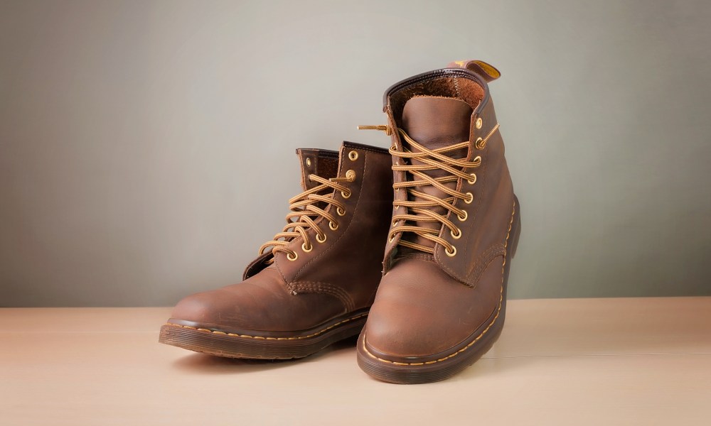 men's brown boots sitting on floor