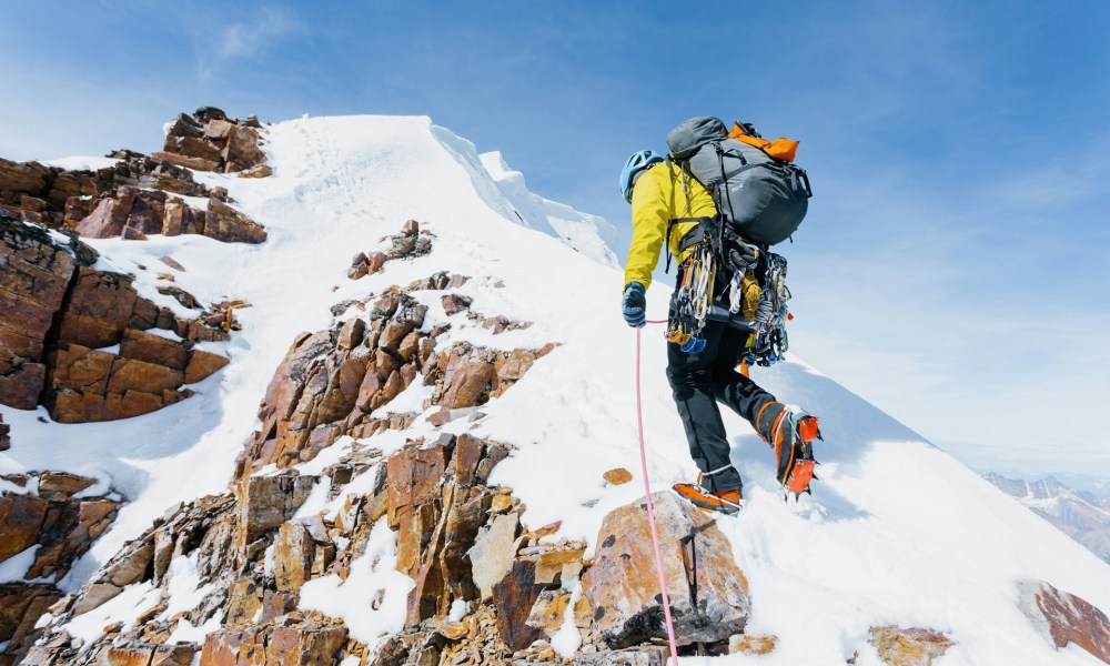 Man climbing a snowy mountain