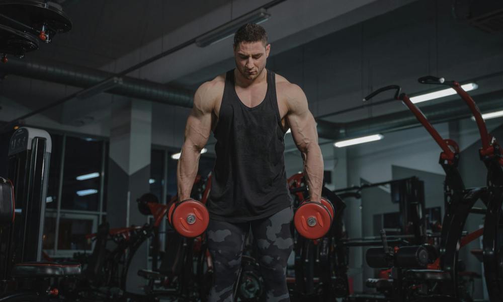 Man in gym holding two barbells