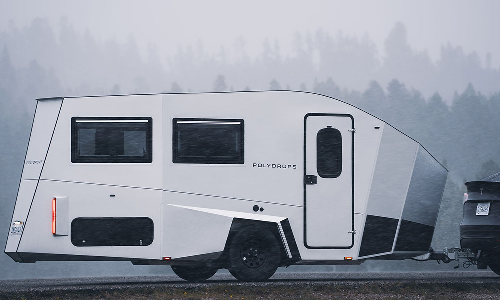 Tesla sedan towing a Polydrops P21 camper trailer.