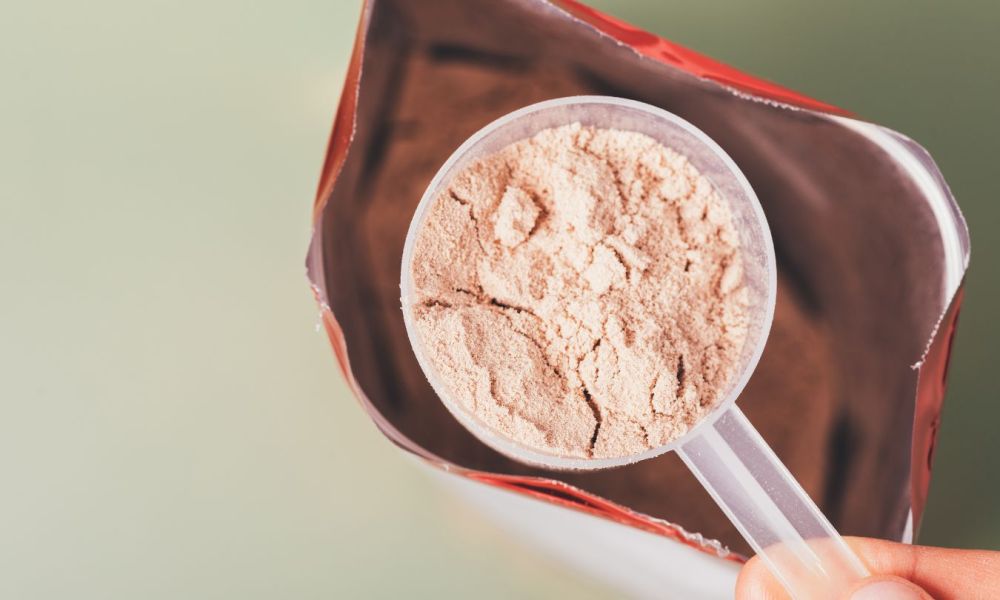 Person scooping protein powder out of a bag