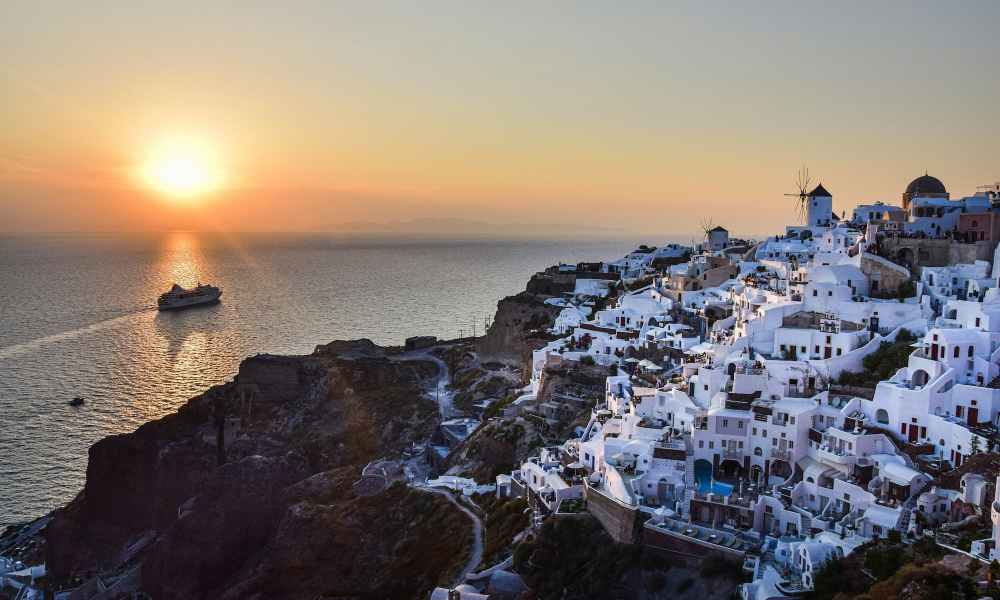 White houses overlooking the ocean during sunset