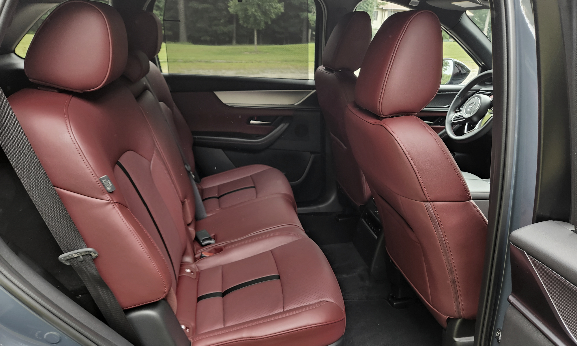 2025 Mazda CX-70 PHEV interior view of back seats taken from open passenger side door.