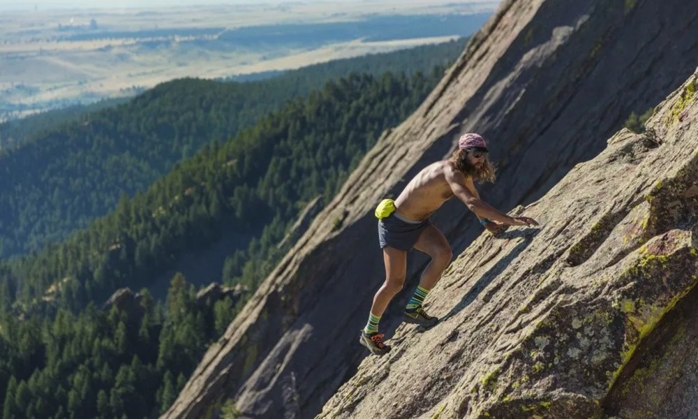 Anton Krupicka scrambling up mountain