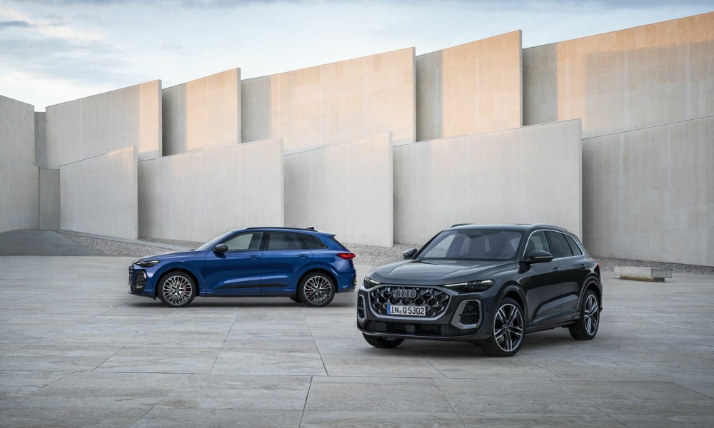 Third generation Audi SQ5 and Q5 parked with concrete walls in the background.