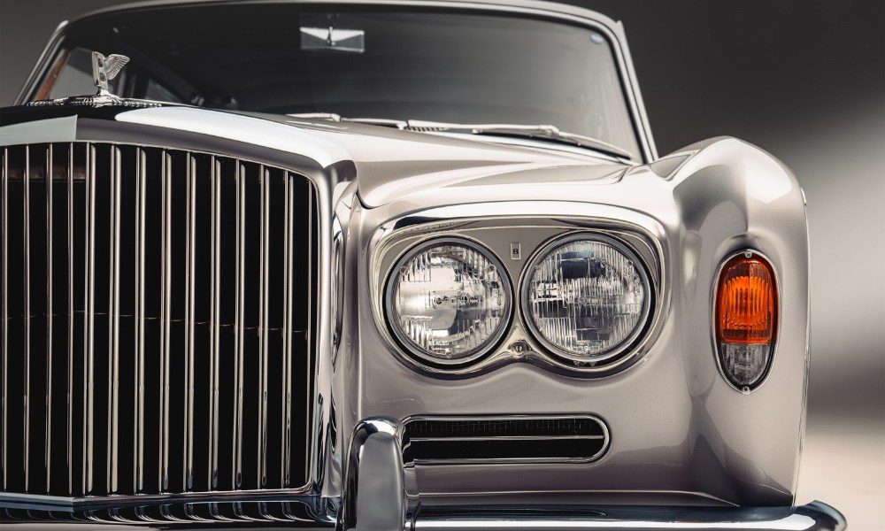 Thoroughly recomissioned and restored Bentley T-Series standad saloon front of car including left half of the grill and hood ornament.