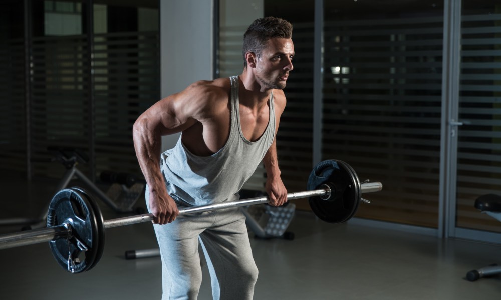 Man wearing gray vest doing bent-over barbell row