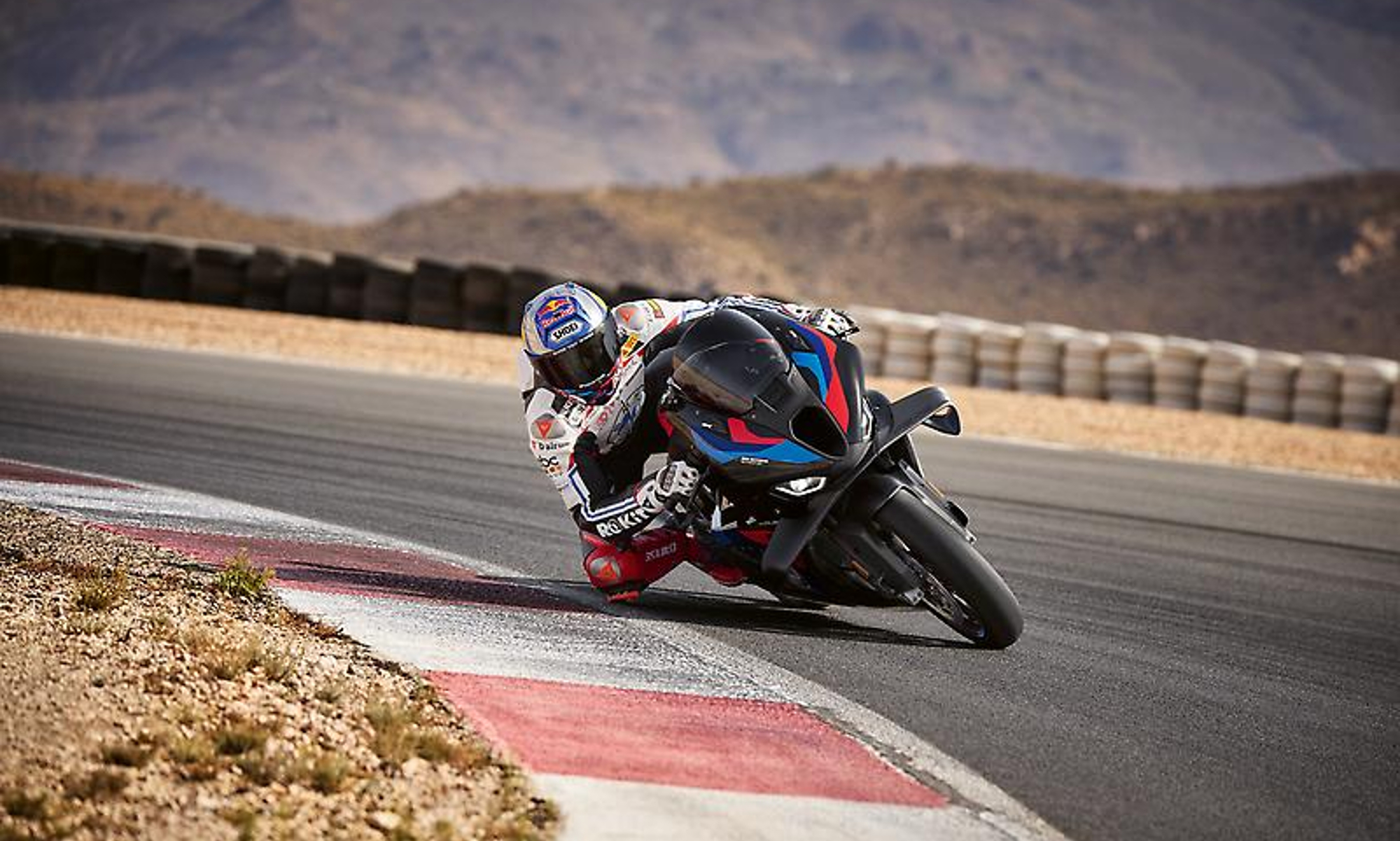 2025 BMW M 1000 RR cornering deep on a race track.