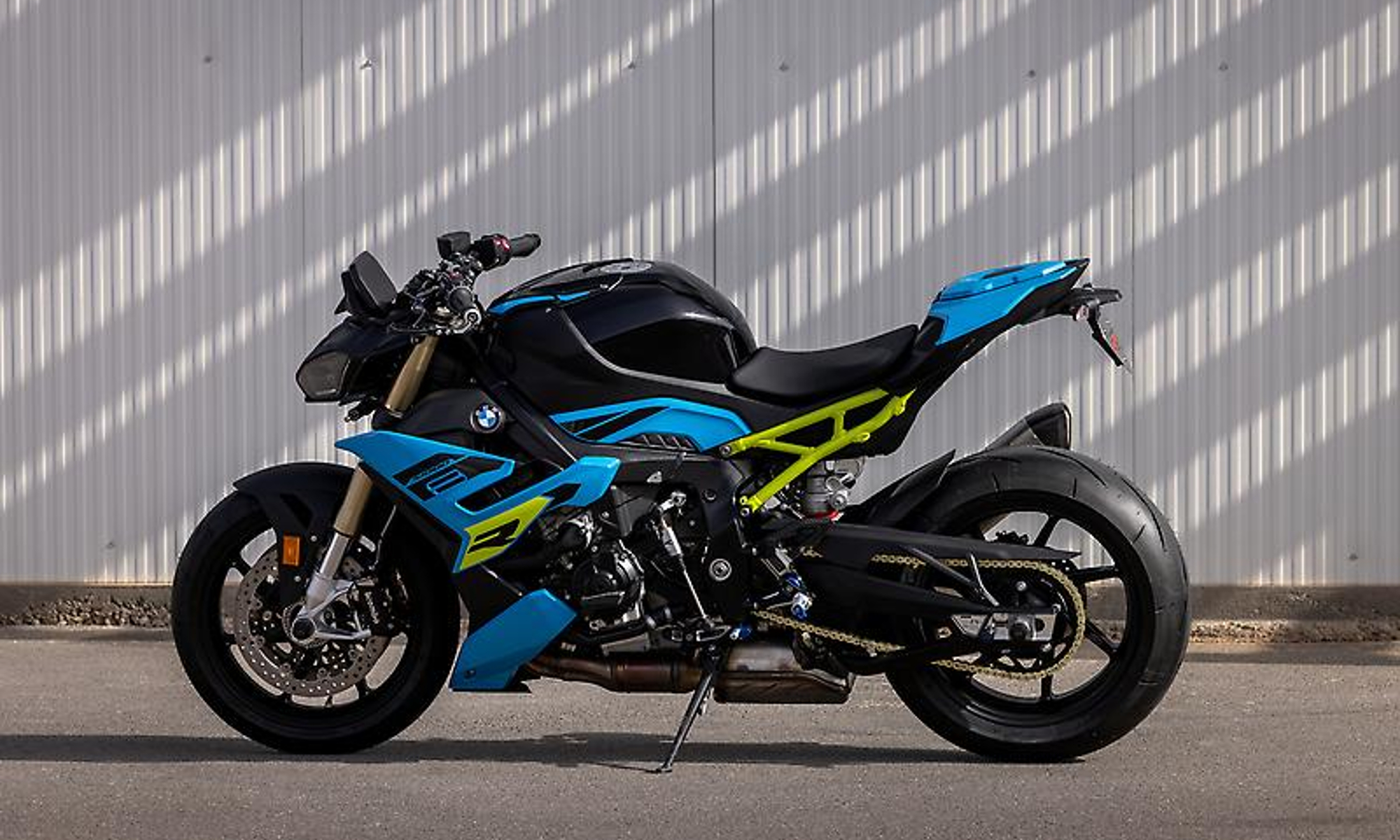 2025 BMW S 1000 R parked by a race track timing tower.