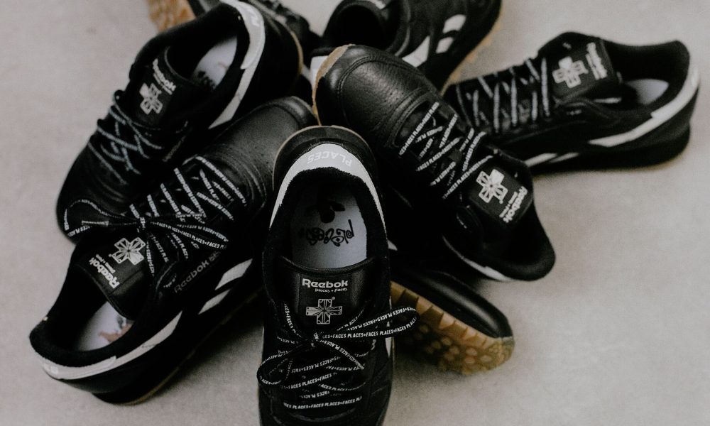 pile of black Reebok sneakers