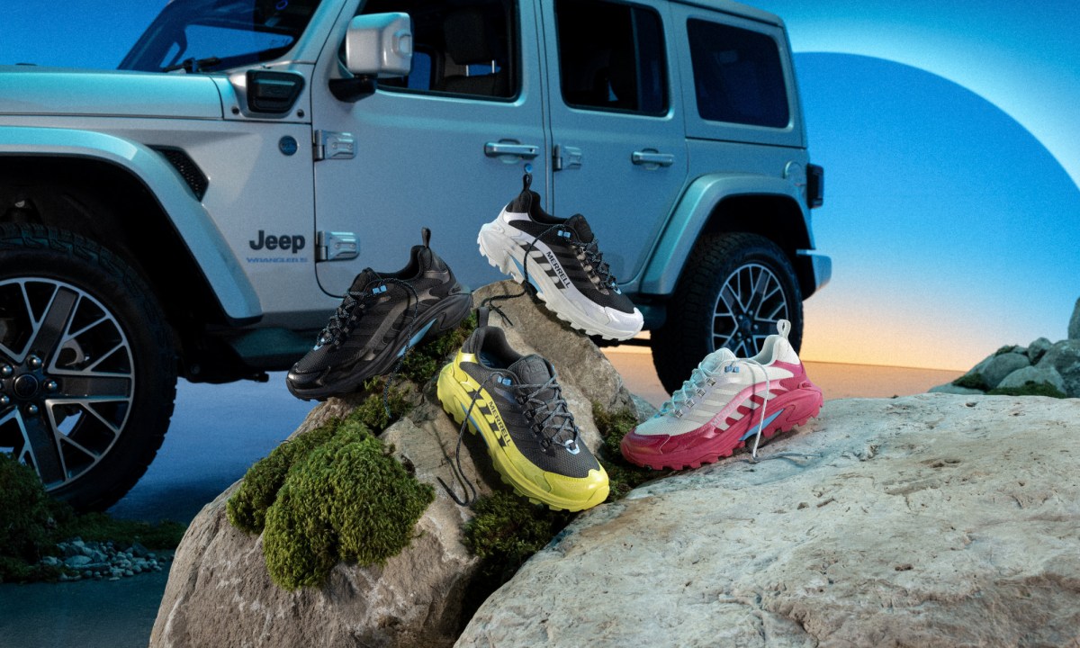 jeep in background, hiking boots sitting on rock in front