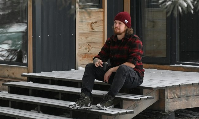 Man on steps in a flannel