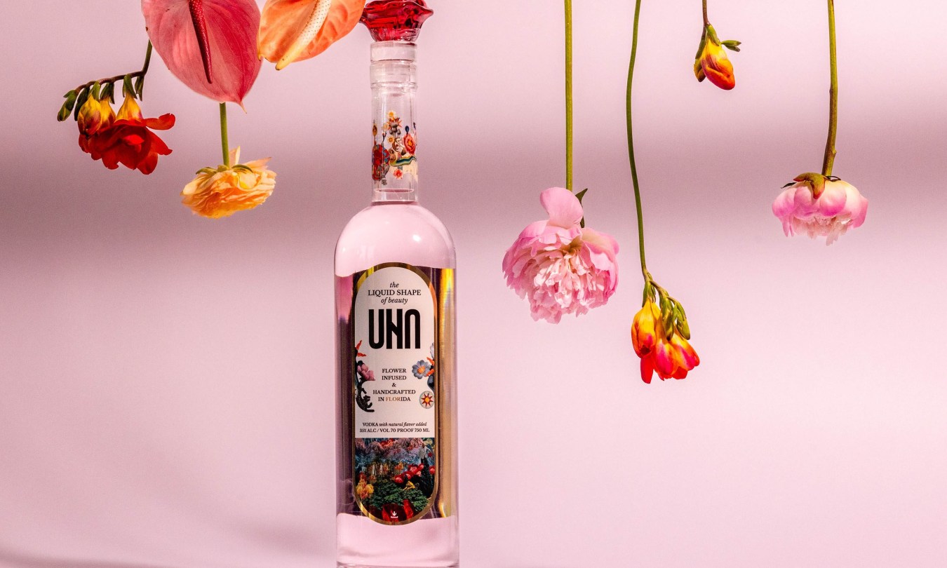 UNA Vodka bottle with Begonia flowers and pink background.