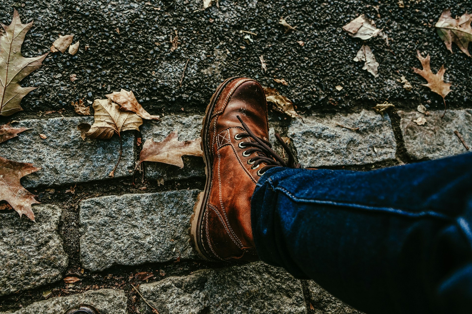 man wearing boots on street