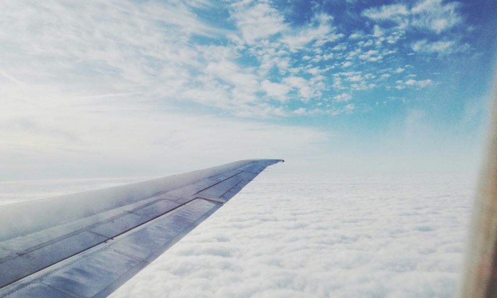 airplane wing through sky