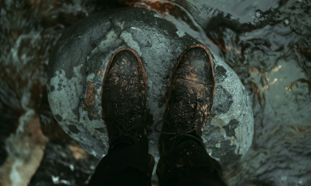 dirty men's boots on rock