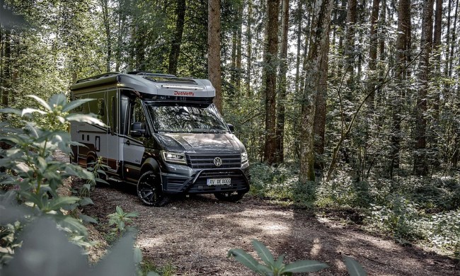 Dethleffs Globebus 4x4 Performance motorhome parked on a heavily wooded forest road.