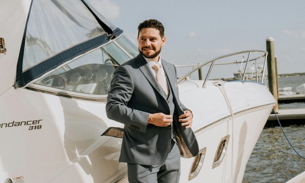 Man in a suit by a boat