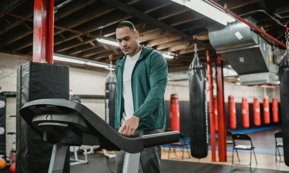 Man on treadmill walking using machine in gym