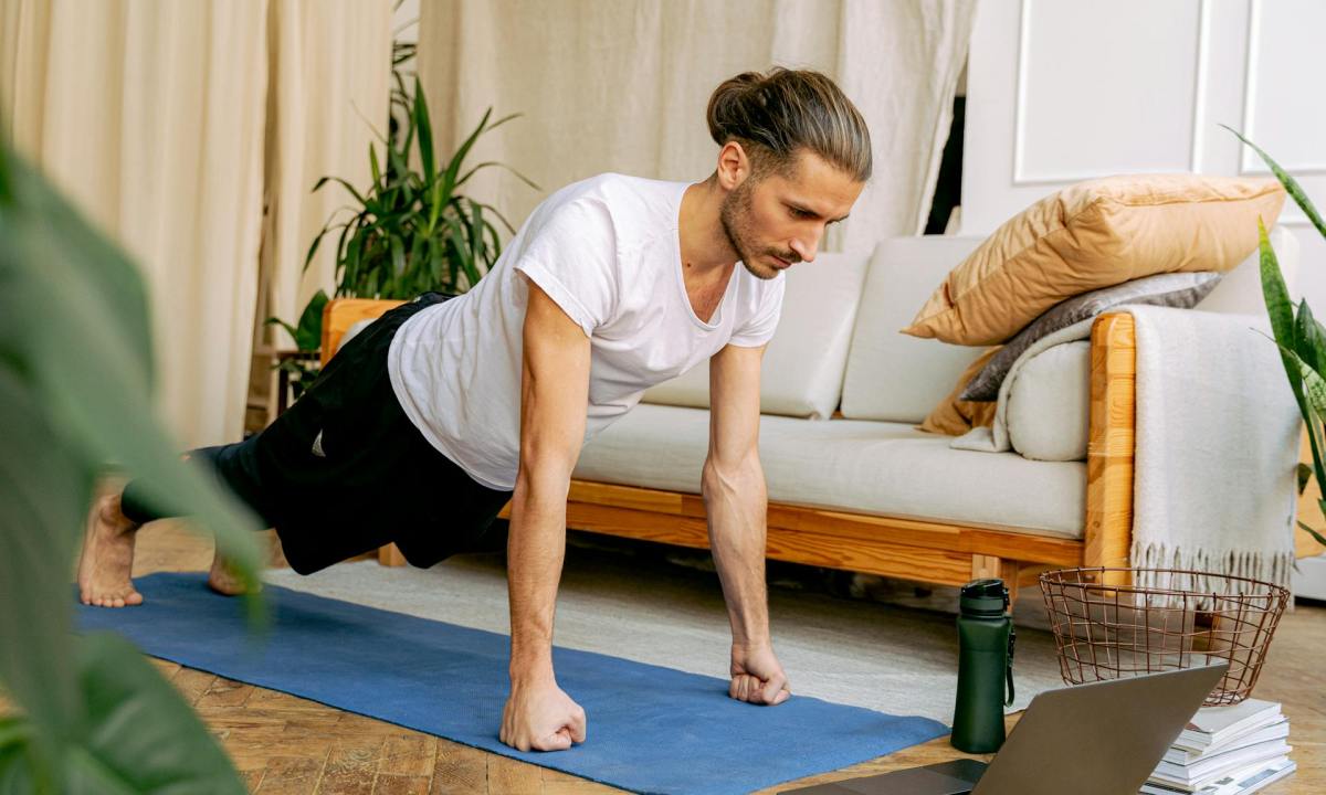 Man doing a plank on a yoga mat