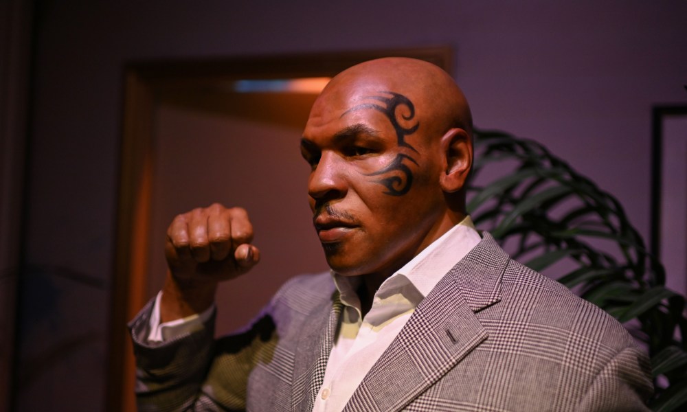 Mike Tyson making fist wearing a suit