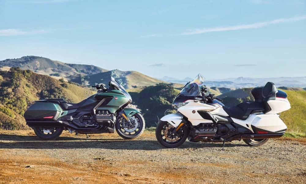 A Honda Gold Wing and a Honda Gold Wing Tour Airbag Automatic DCT parked by the side of a mountain road.