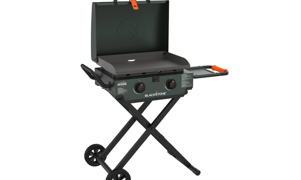 A Blackstone Adventure Ready 2-Burner 22" Propane Omnivore Griddle with Flexfold Legs with the hood open.