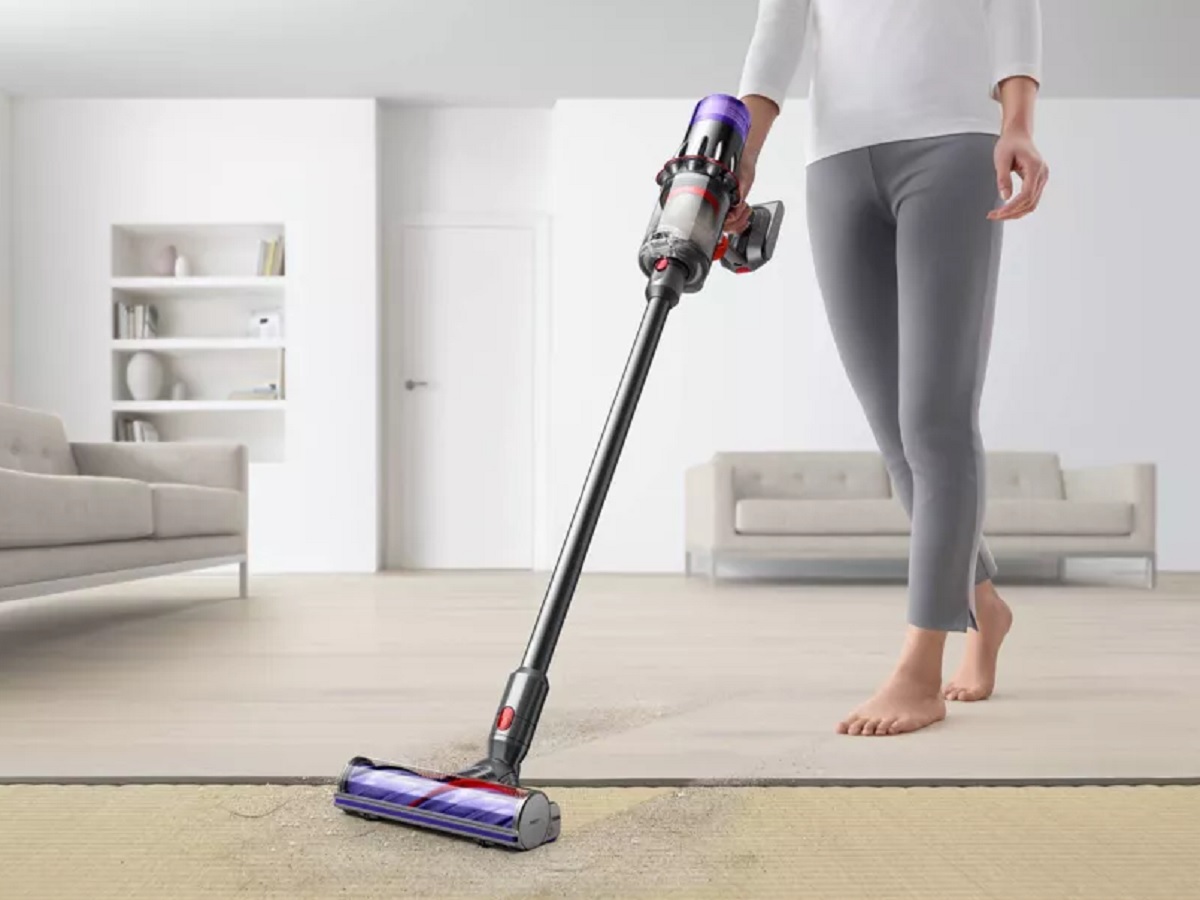 A person using the Dyson Digital Slim cordless vacuum.