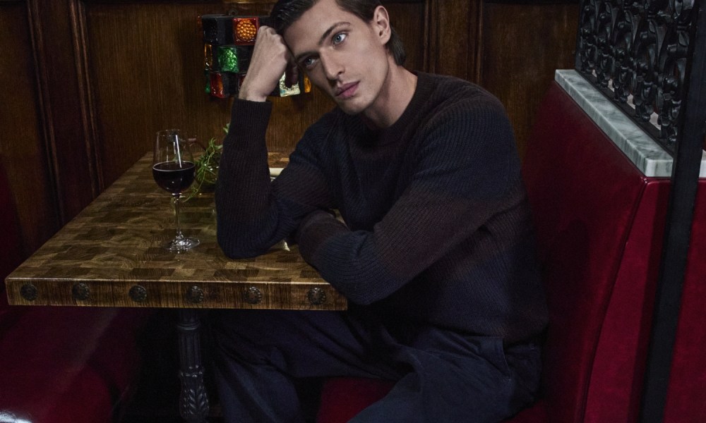 Man sitting at diner table in Vince holiday attire