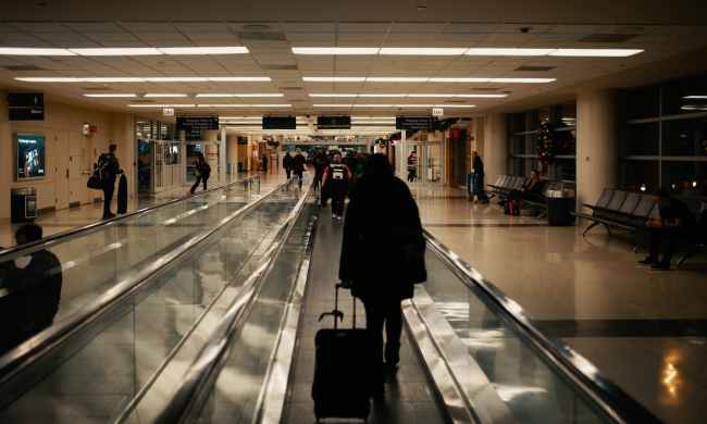 Person rolling luggage through the airport