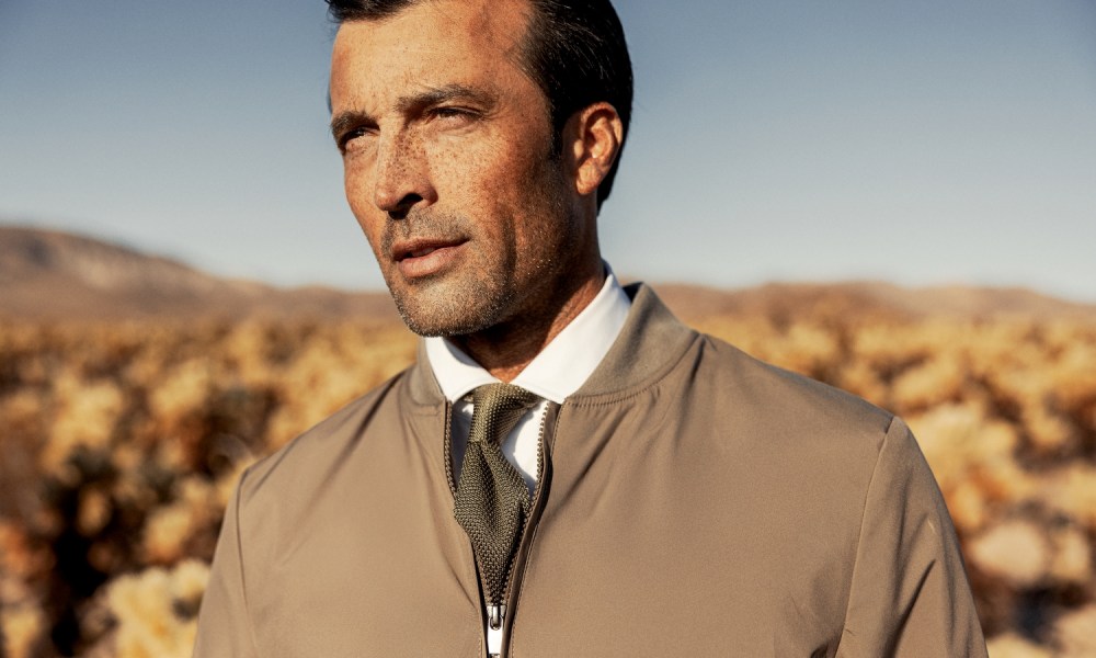 Robert Talbott bomber jacket with shirt and tie in the desert