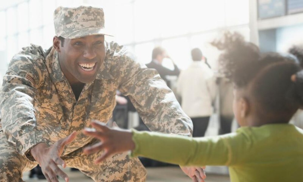 Service member greeting child