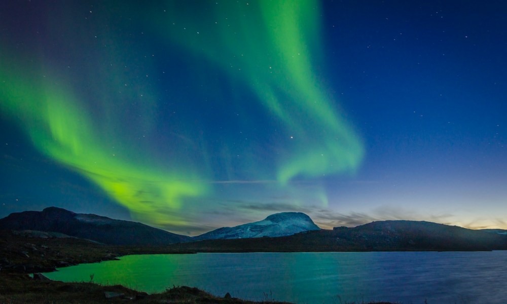 Aurora borealis over body of water during nighttime