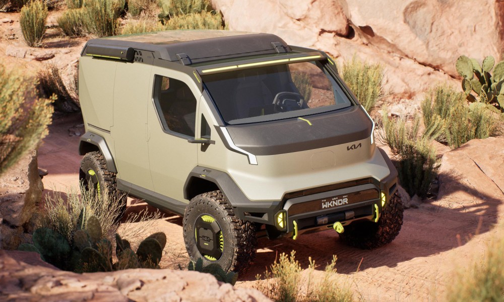 Kia's PV5 WKDNR Concept van parked among cacti on a desert trail