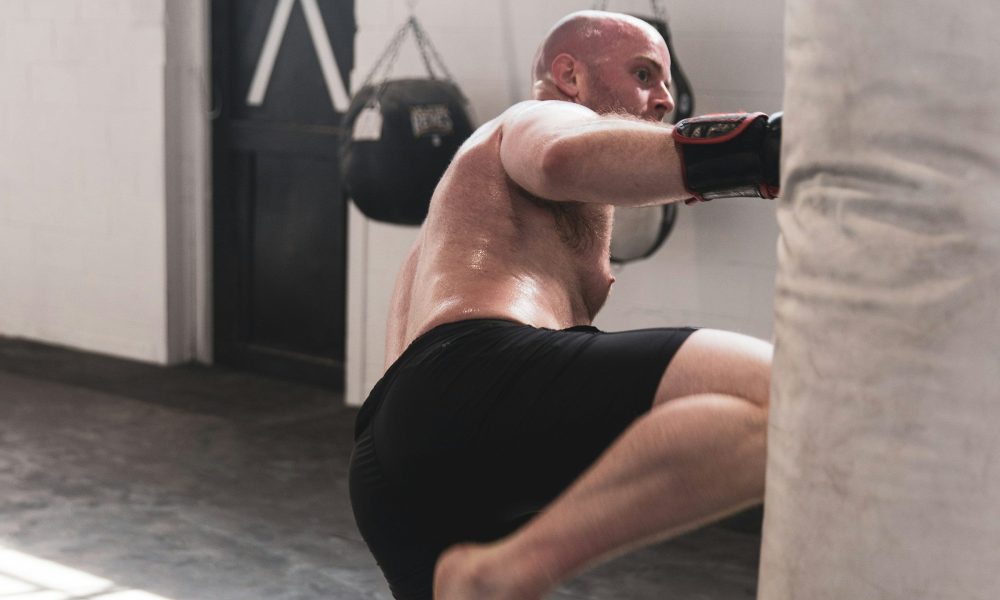 man boxing shirtless gym boxing gloves