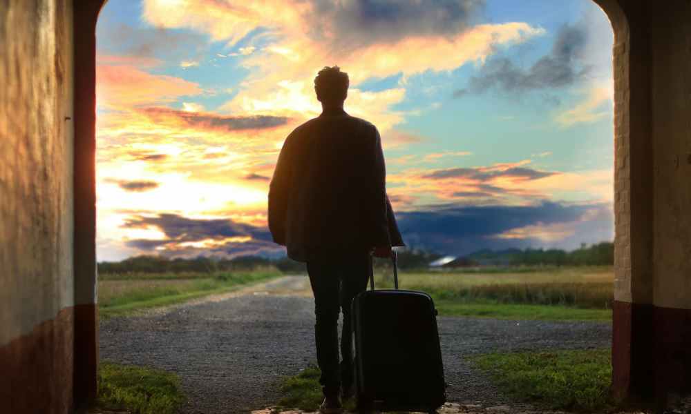 man with suitcase standing outside