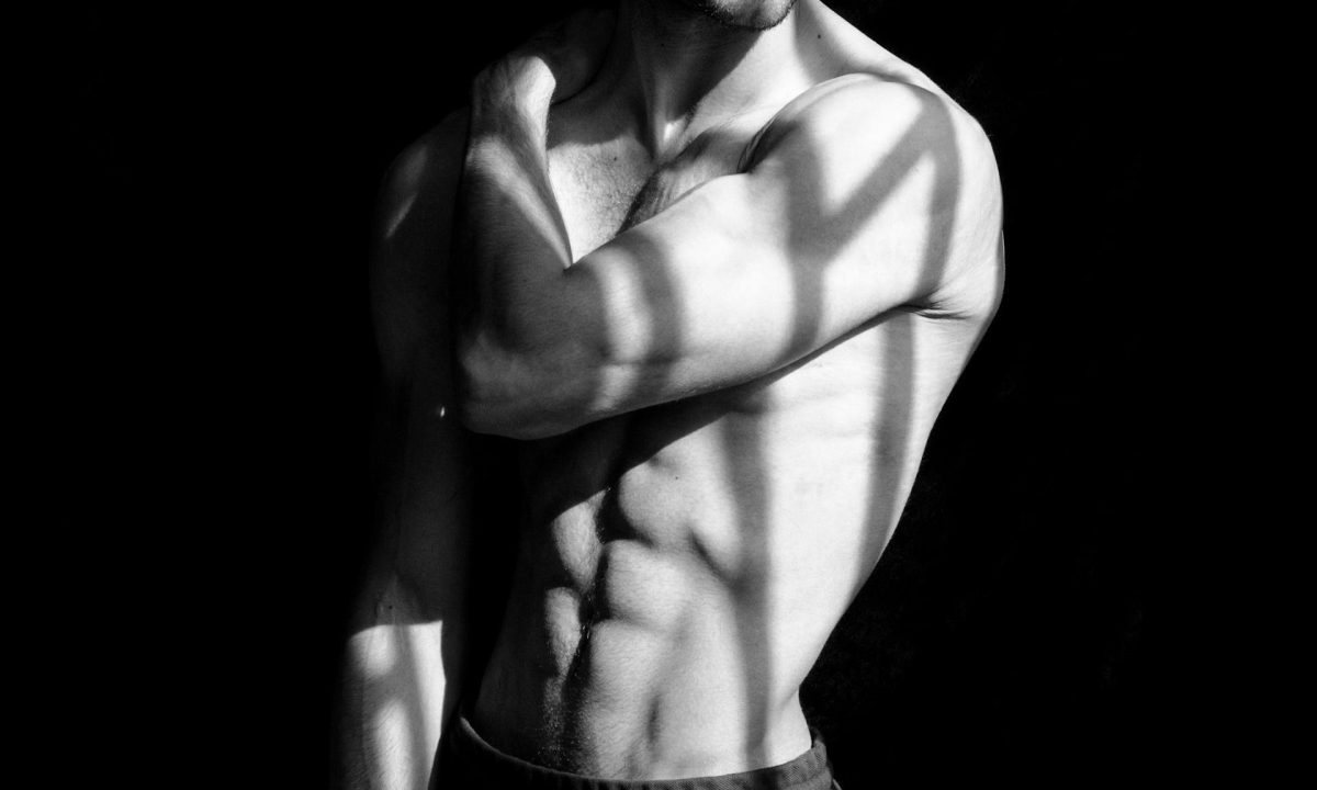 man doing shirtless wearing hat black background muscle abs