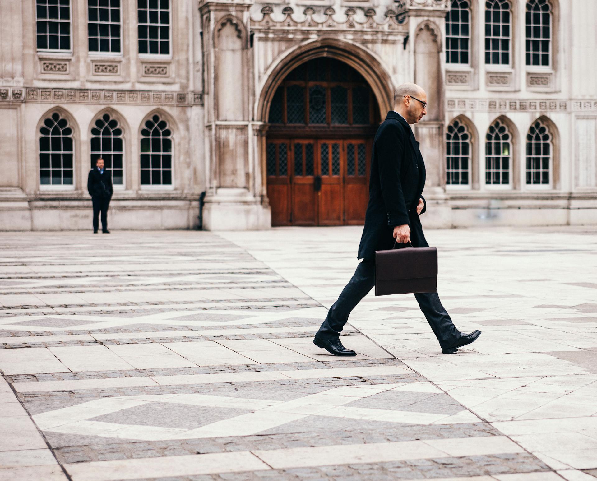 business man walking outside with briefcase suit.