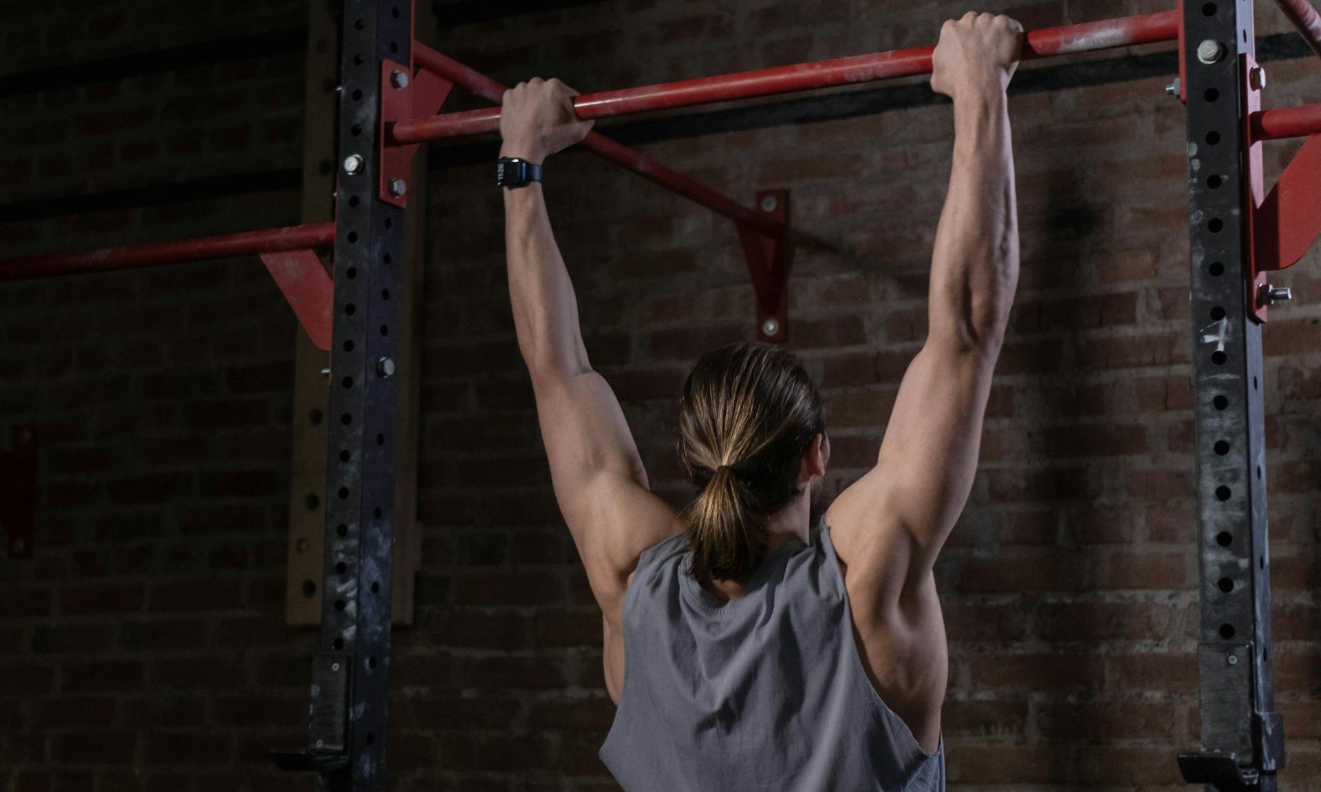 pull up bar dead hang exercise man holding hanging from bar