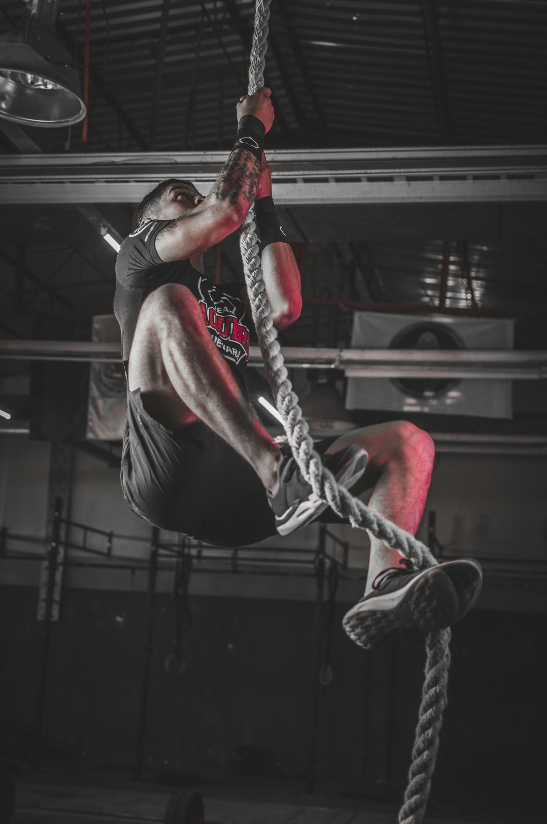 high intensity interval training man climbing a rope circuit training high intensity exercise